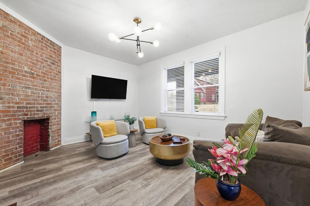 a living room with a couch and a fireplace at Bright & Clean 2BR Near Downtown Porch Parking in Pittsburgh