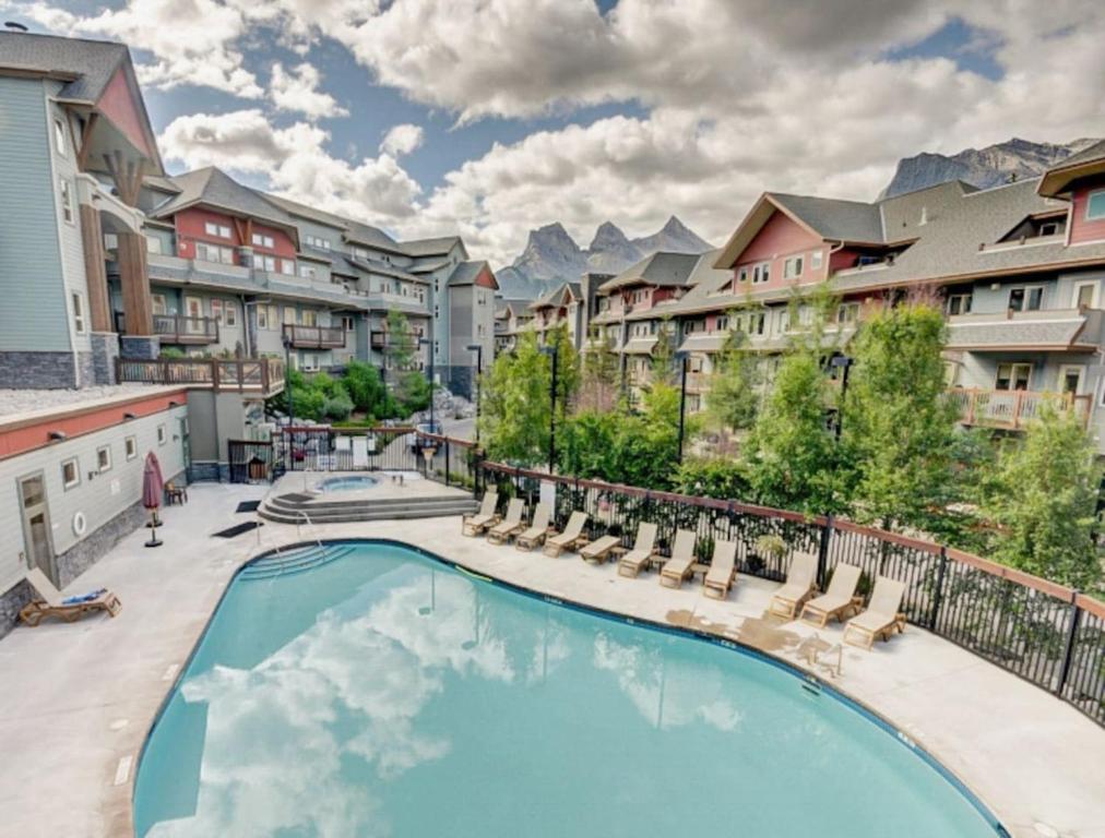 a swimming pool at a apartment complex with a resort at Top Floor Beautiful Mountain Views! 2 Bed 2 Bath in Canmore