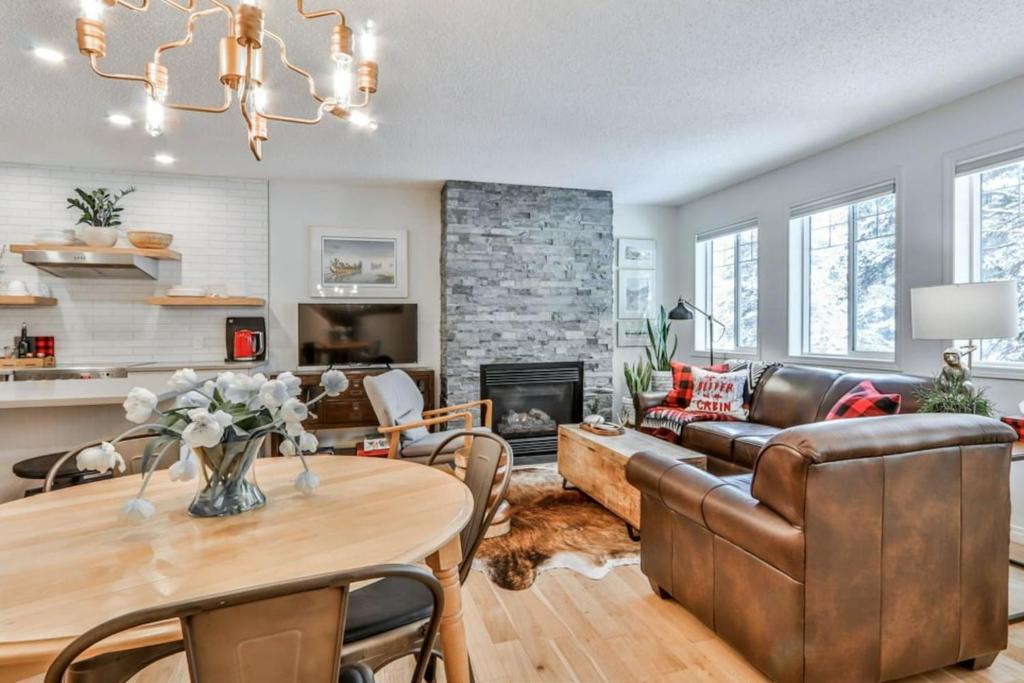 a living room with a couch and a table at A Rustic Modern Mountain Condo - 2 bed, 2-Level in Canmore