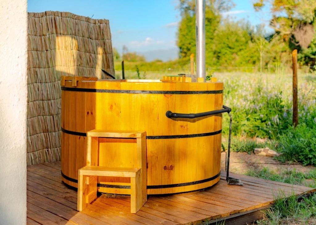 a yellow barrel sitting on a wooden deck at Refugio Campestre, Cabaña con Tinaja Opcional 
