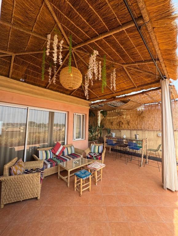 a living room with couches and chairs and a table at Maison Mamdy Triplex & Rooftop in Marrakesh