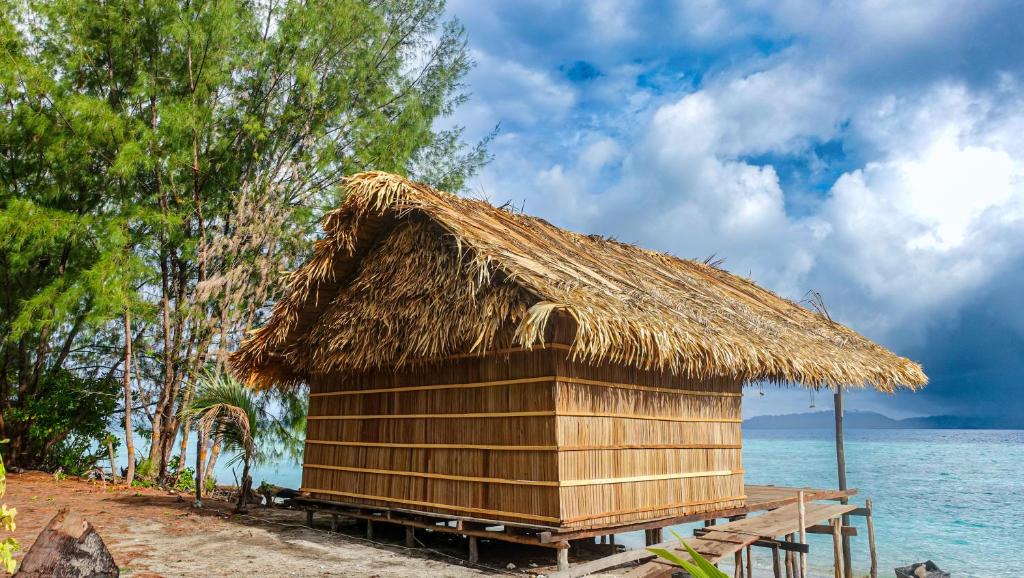 a hut on the beach near the water at Villa Homestay in Mesemta