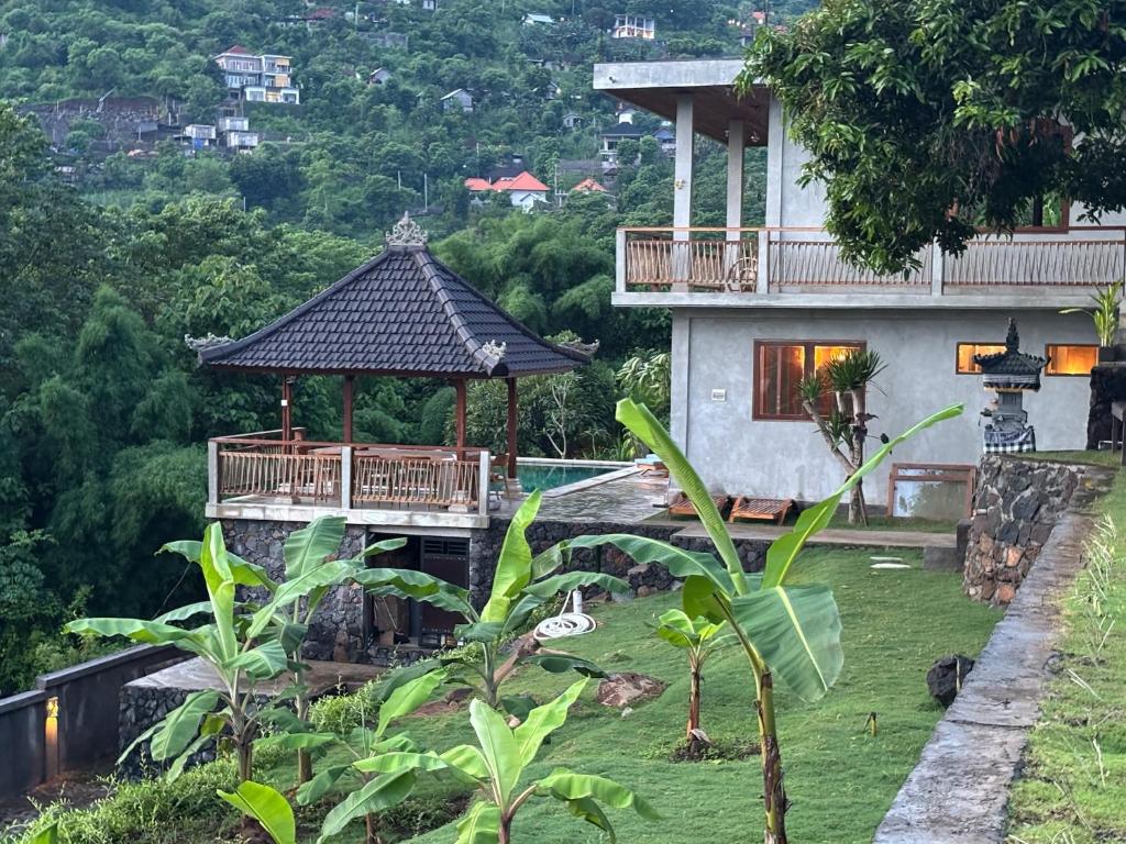 a house with a gazebo in front of it at First Light Villa at Lipah Beach, Amed in Amed