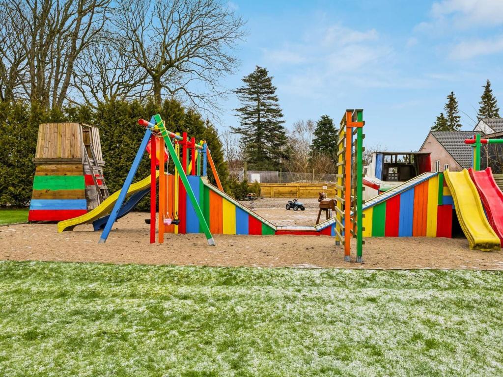 a playground with colorful play equipment in a park at Expansive Villa near Ribe in Skærbæk