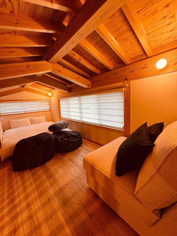 a bedroom with two beds and a wooden ceiling at Tiny House - Vacation STAY 12059v in Ōtakuchi