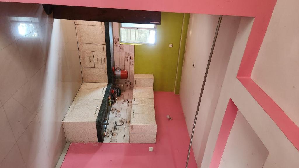 a view of a bathroom with a red floor and stairs at Singh ManSion in Purnea