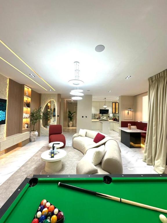 a living room with a pool table and a couch at Luxury 2 Bedroom Apartment with 2 Private Patios in Lekki Phase 1 in Lekki