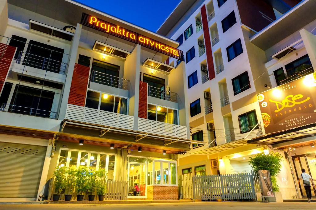 a building with a sign on the side of it at Prajaktra City Hostel in Udon Thani