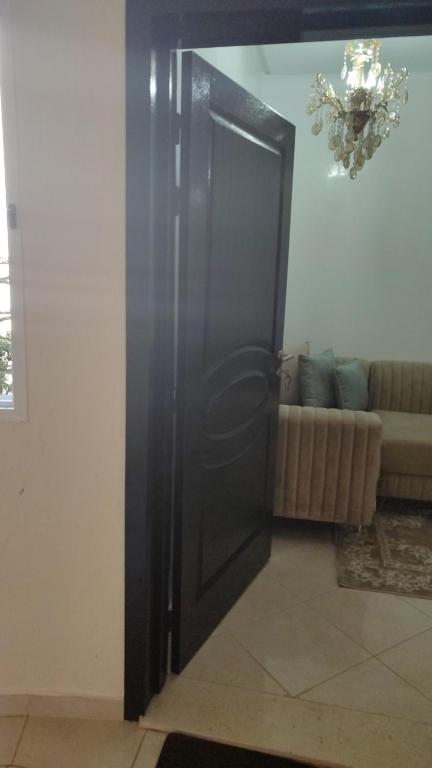 a black door in a room with a couch at maison achab in Asilah