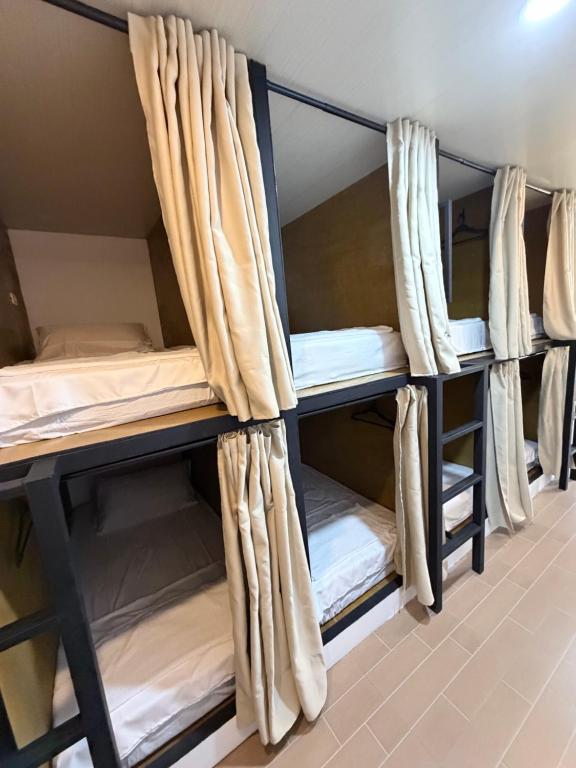 a group of bunk beds in a room at La Paula Hostel in San Juan