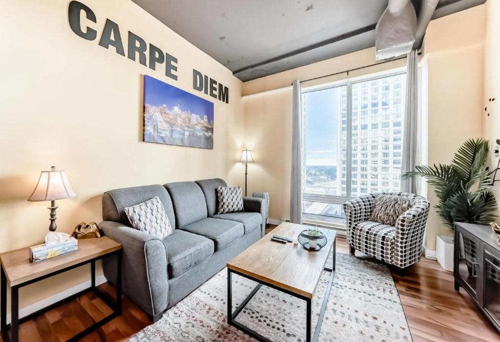 a living room with a couch and a table at 2 Full Beds, Rogers Place Downtown Central, Memorable 1 Bedroom Condo in Edmonton