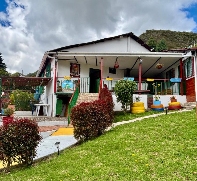 a house with colorful plants in front of it at Casa campestre Hotel Cerro Fuerte in Sopo
