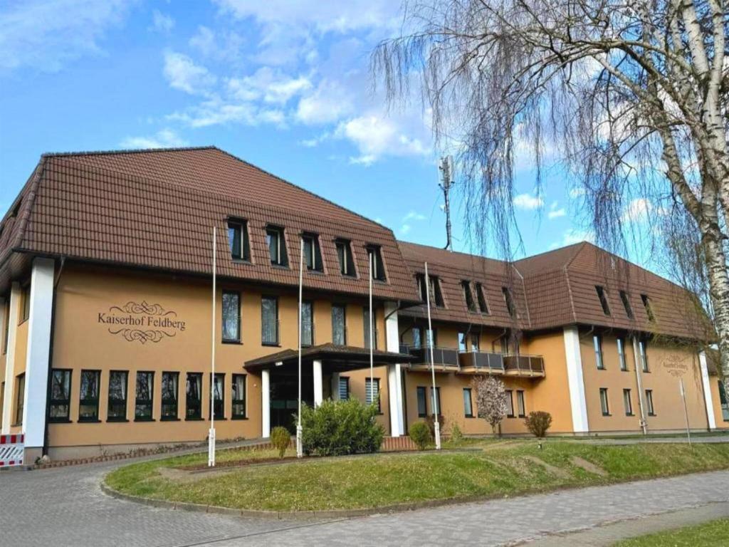 a large building with a brown roof at Kaiserhof Feldberg- Standard Double Room in Feldberg