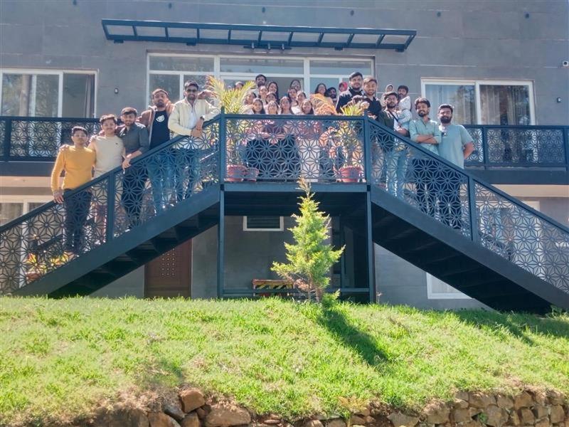 a group of people standing on a balcony at Shans Valley in Kotagiri