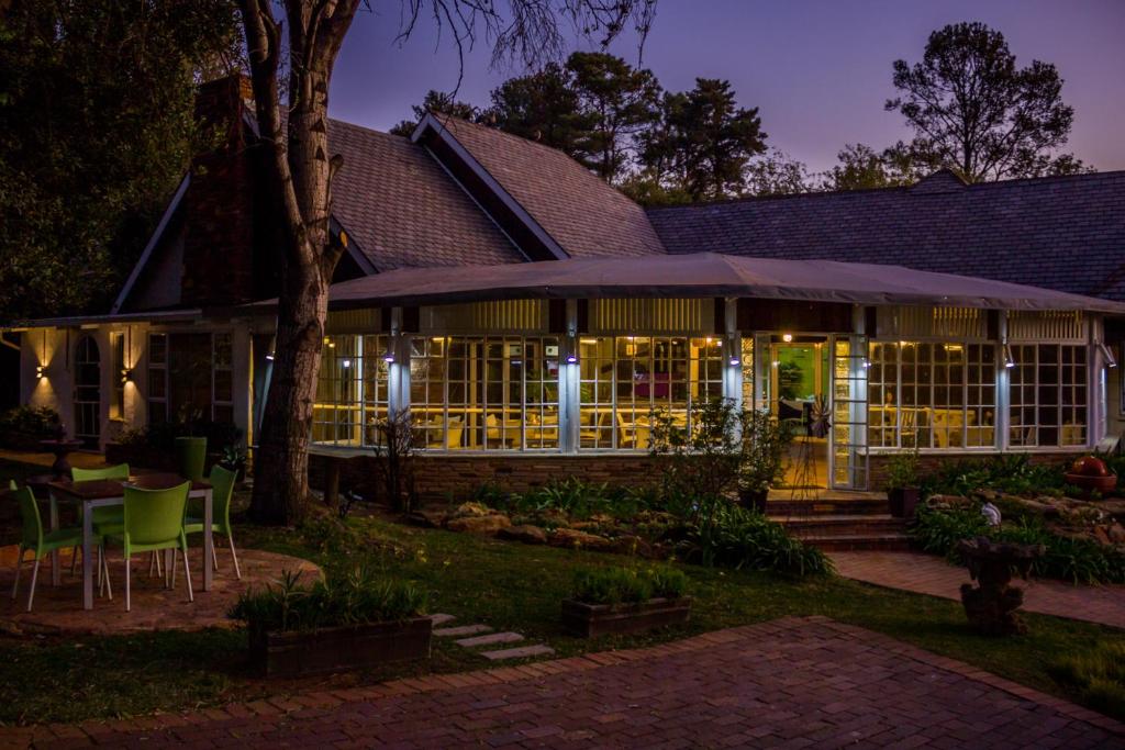 a building with a table and chairs at night at Glendower View Guest House in Johannesburg
