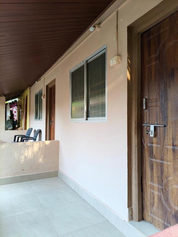 a front door of a house with a porch at janaki Homestay in Gokarna