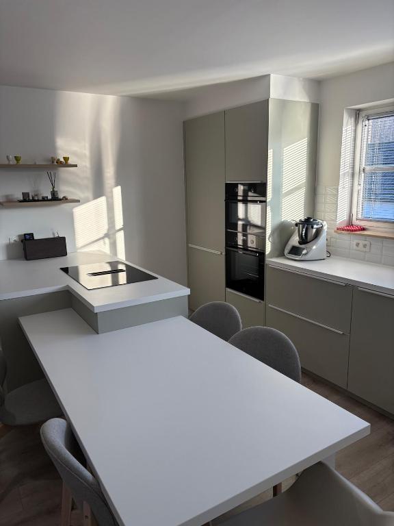 a kitchen with a white table and chairs in it at Spacious duplex apartment in Overijse in Overijse