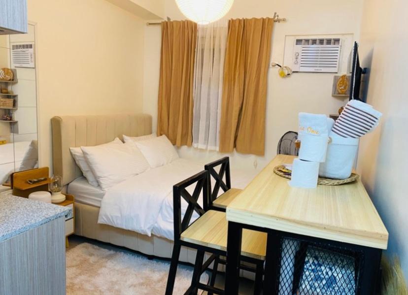 a small room with a bed and a table and chairs at Casa Ona in Manila