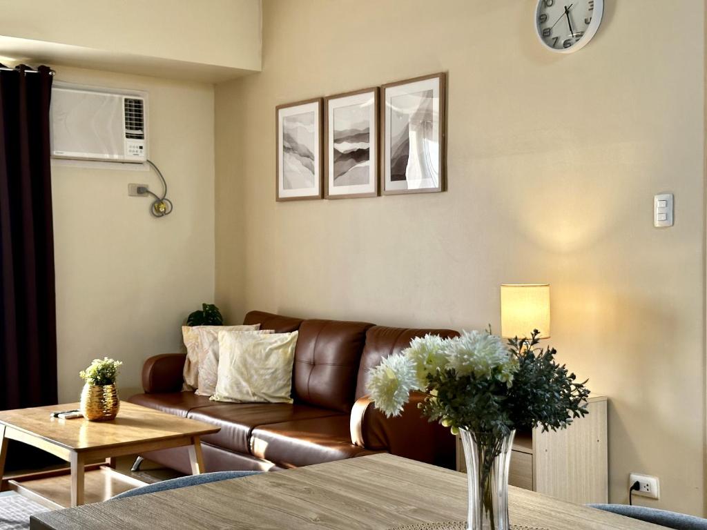 a living room with a couch and a table at 2-Bedroom Condo Unit with Balcony at Centrio Tower beside Ayala Centrio Mall Downtown CDO in Cagayan de Oro