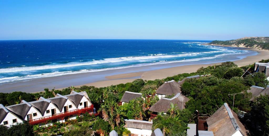 a view of a beach with houses and a train at Crawfords Beach Lodge in Chintsa
