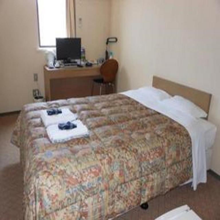 Postel nebo postele na pokoji v ubytování Hotel Kimitsu Hills