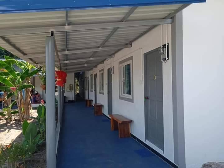 a building with a blue walkway with benches on it at Double P in Ban Phlong Sawai