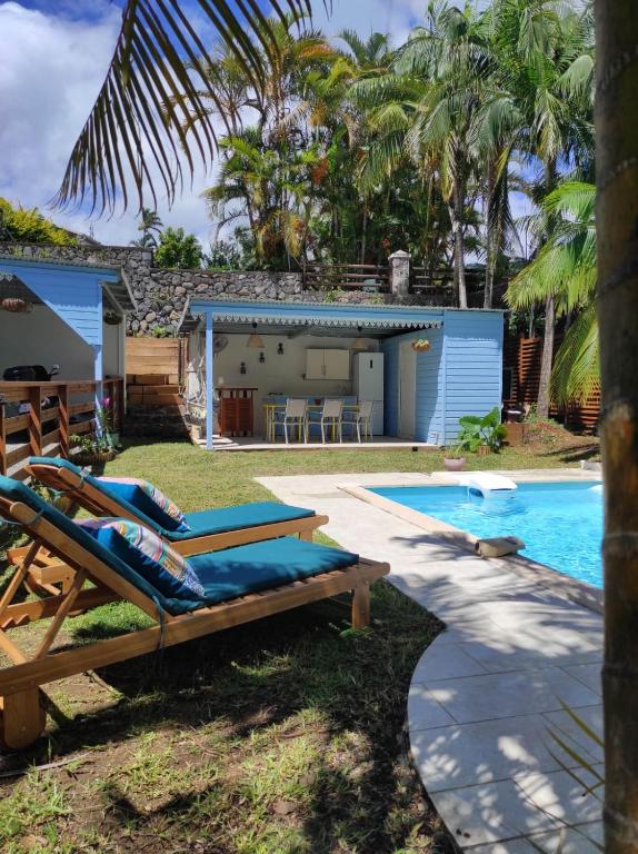 a villa with a swimming pool and a resort at La Palmeraie Créole in Sainte-Marie