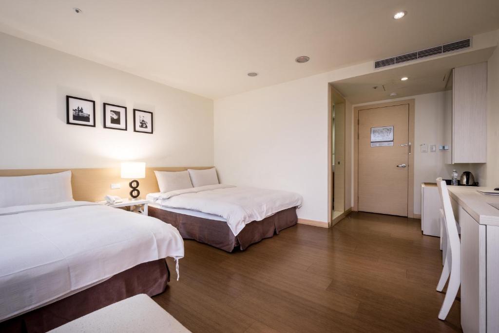 Postel nebo postele na pokoji v ubytování Wemeet Hotel Taipei