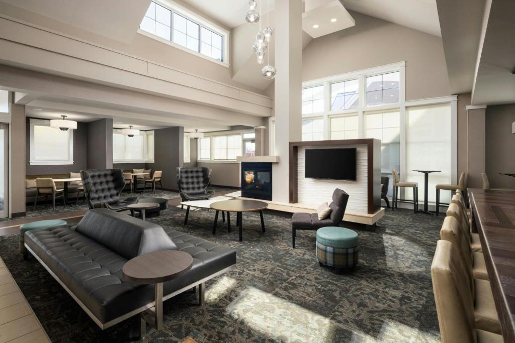 a large living room with a couch and a tv at Residence Inn by Marriott Springfield Chicopee in Chicopee