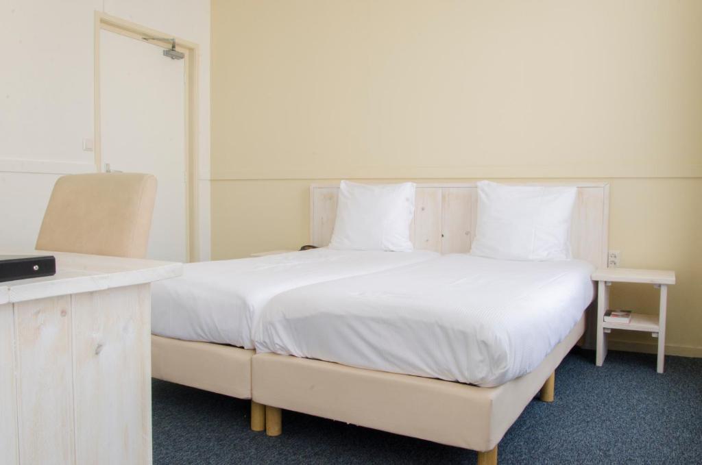 Postel nebo postele na pokoji v ubytování City2Beach Hotel