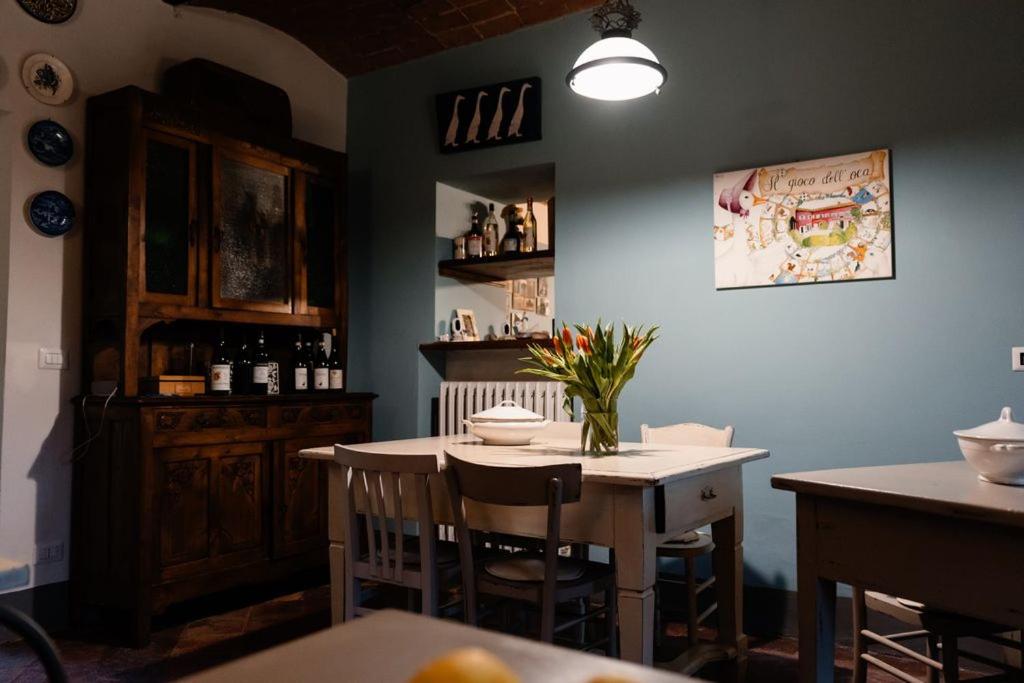 a dining room with a table and a table and chairs at Agriturismo Il Gioco Dell'Oca in Barolo
