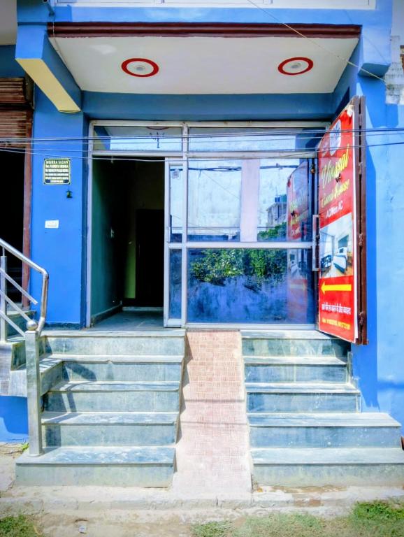 a blue building with stairs in front of it at Virasat Guest House in Lucknow