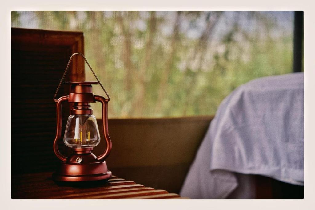a brown lantern sitting on top of a table at NATURE LOVERS ADVENTUREs in Maasai Mara National Reserve