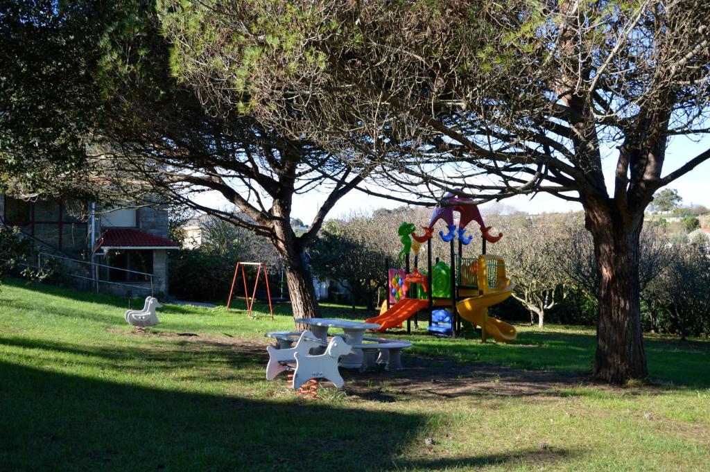 a park with a playground with a swing set at Casa Vacacional Mazo de Arriba in Santander