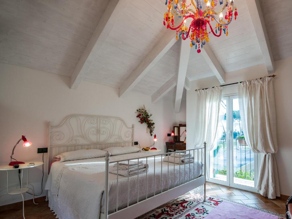 a bedroom with a bed and a chandelier at Guest House Arancia145 in Ceriale