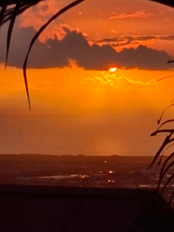 a sunset view from the top of a building at Chalet en bois accés piscine in La Possession