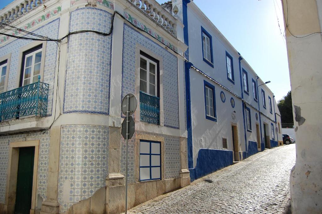 a blue and white building on a street at Hospedaria Santa Maria in Beja