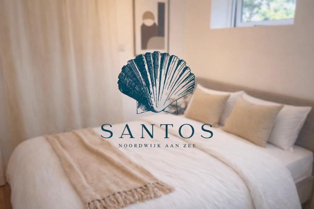 a hotel room with a santos sign on a bed at Santos in Noordwijk aan Zee