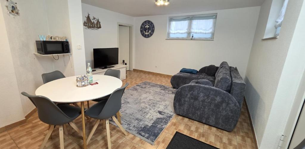 a living room with a table and a couch at Stiller Hafen in Herbolzheim