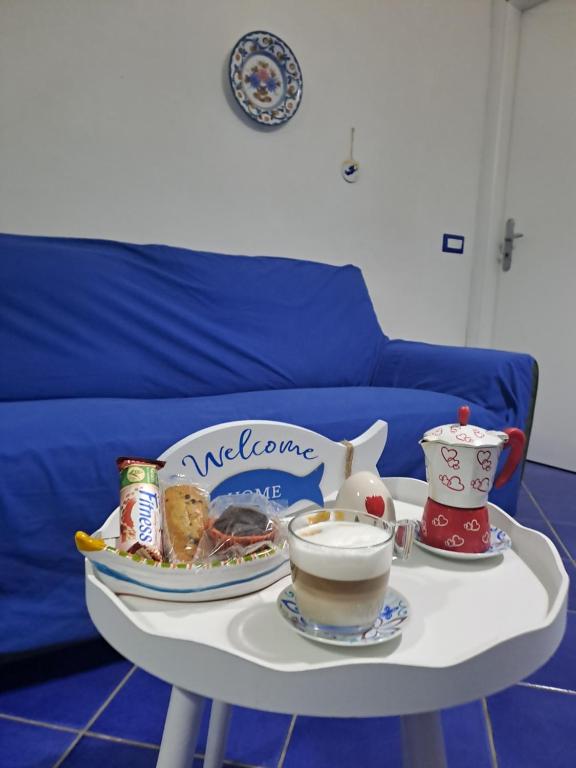 a table with a tray of food and cups on it at Il nido dei nonni in Maiori