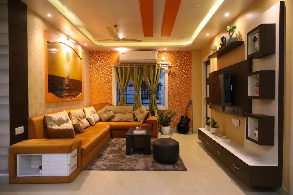 a living room with a couch and a table at Fussed Over Retreat in Siliguri
