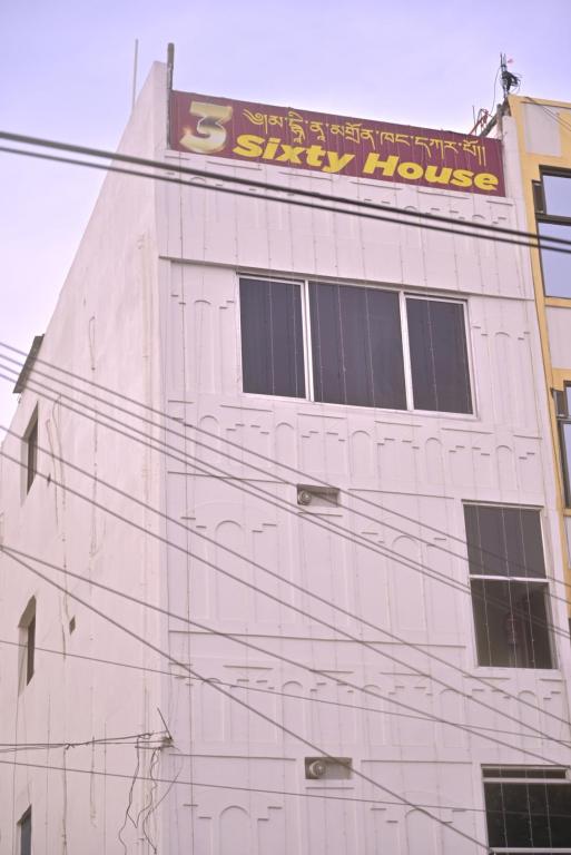 a white building with a sign on the side of it at 3 Sixty House in Bodh Gaya