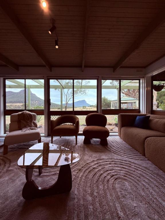a living room with a couch and chairs and a table at Southern Grampians Lookout in Dunkeld