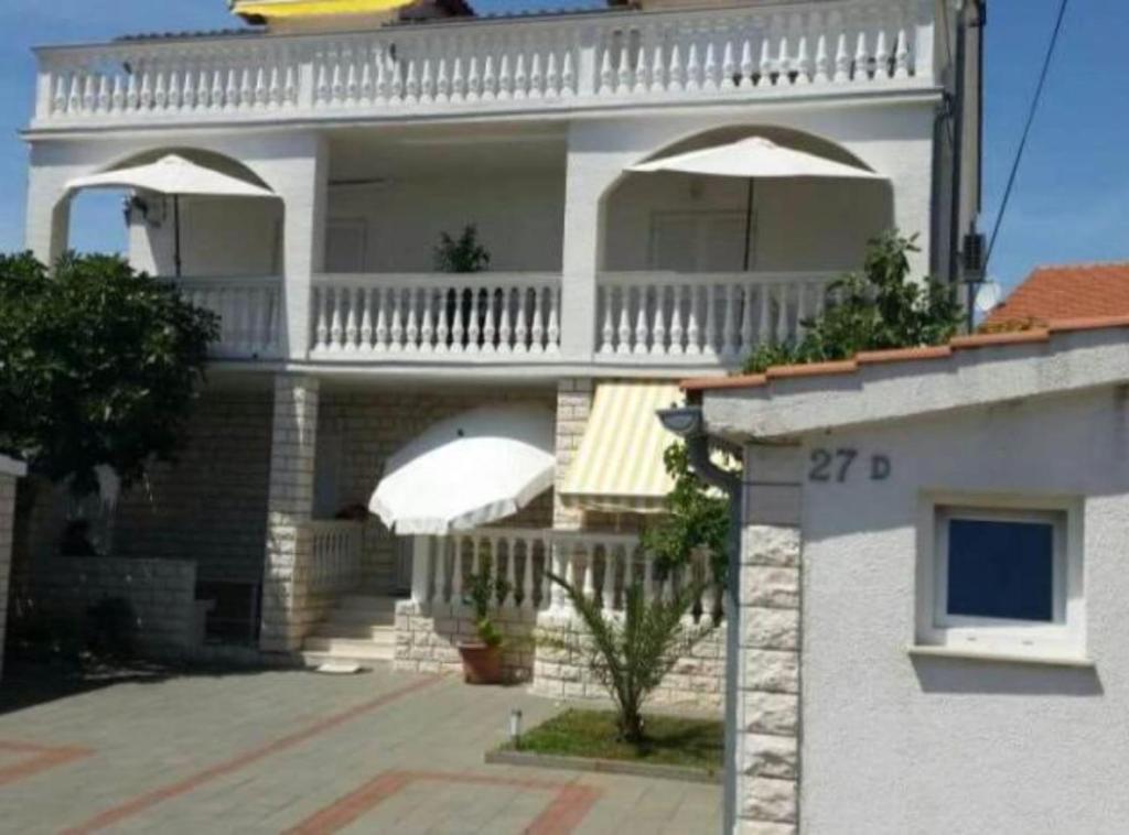 a large white house with a balcony on top of it at Villa Ivan Vodice in Vodice