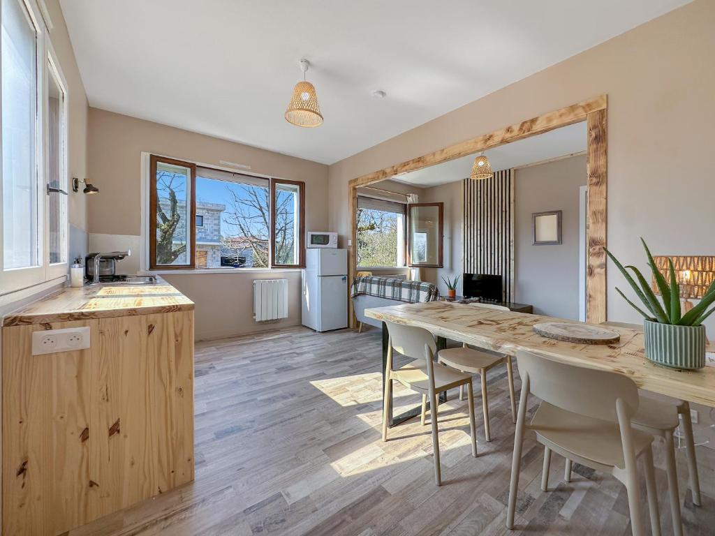 a kitchen and dining room with a table and chairs at Chez La Mamie in Saint-Jean-de Niost