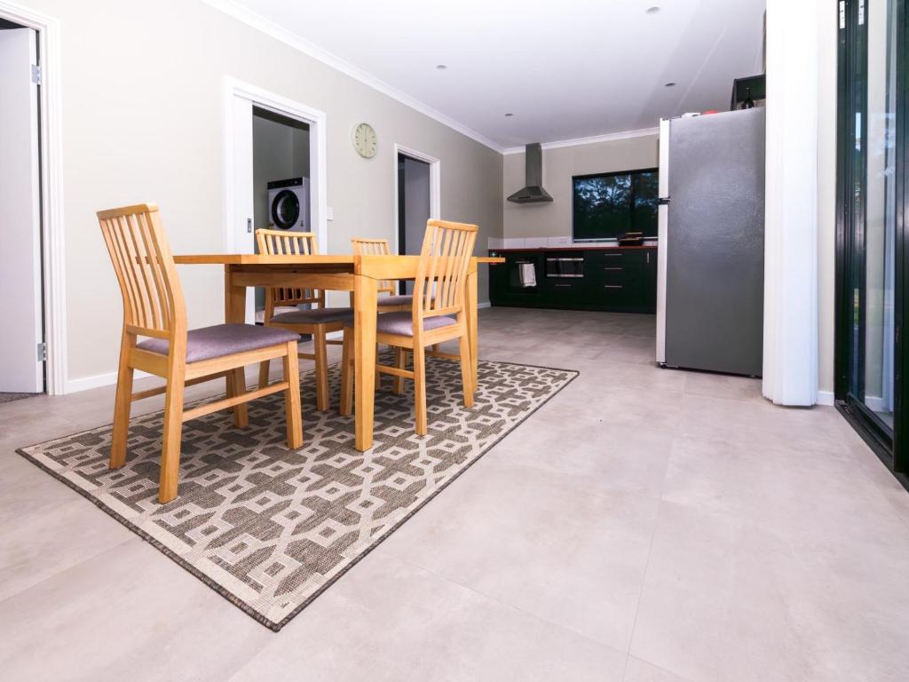 a dining room with a wooden table and chairs at The French River Chalets in Kalgan