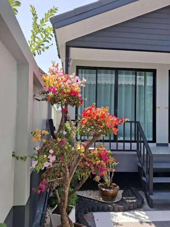 a porch with two bonsai trees with flowers at Adira Residence in Ao Nang Beach