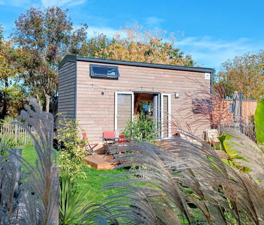a tiny house in the middle of a garden at Tiny house Oléroncoast La-Brée-Les-Bains in La Brée-les-Bains