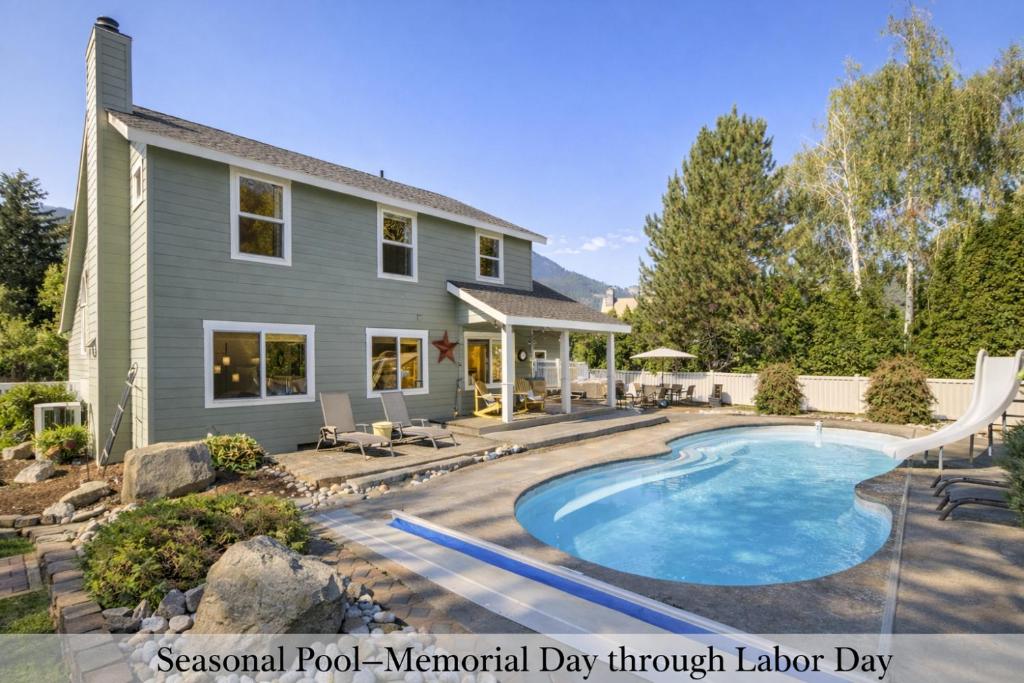 a house with a swimming pool in the yard at All Seasons Getaway in Leavenworth