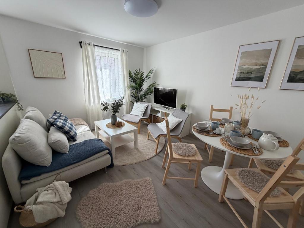 a living room with a couch and a table at Apartmány Loučky Litvínov in Litvínov